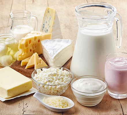 Various fresh dairy products (milk in different forms to consume on wooden background